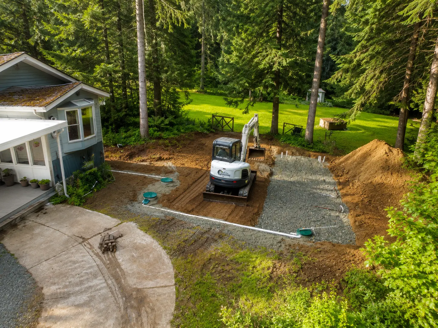 Black Creek residential septic installation site with tank risers and dispersal field under construction