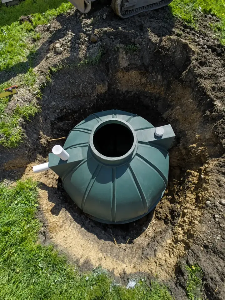 Green septic tank set into an excavation at a Nanaimo property