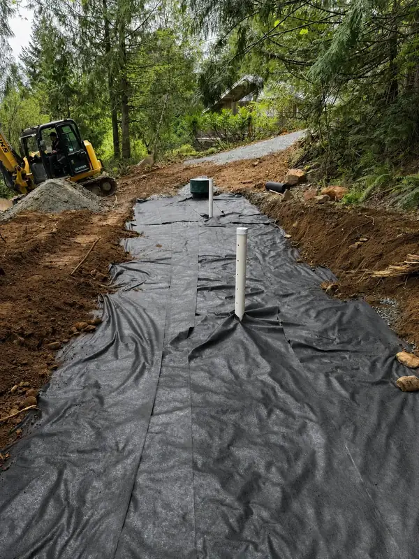 Fabric covering a septic dispersal field during a TTIS gravity septic installation in Port Alberni