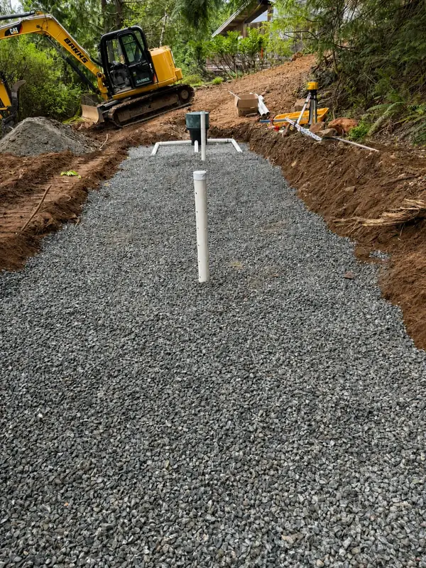 Prepared septic dispersal field on a wooded slope at a TTIS Port Alberni project