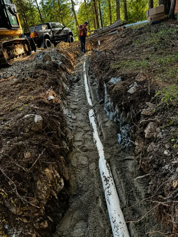 Septic pipeline running up a steep hillside at a TTIS Port Alberni project